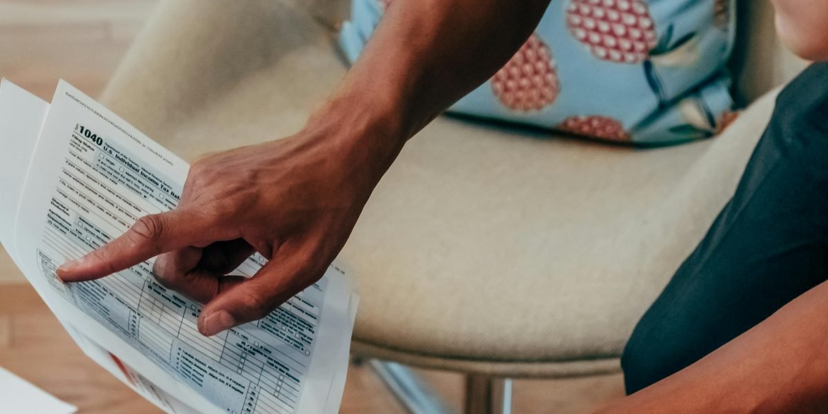 A person meticulously planning their financial future, focusing on strategies for passive income from real estate.