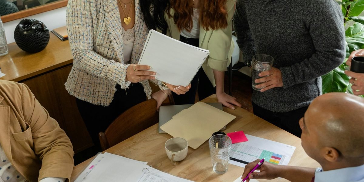 A team of professionals conducting due diligence, reviewing documents and discussing potential risks.