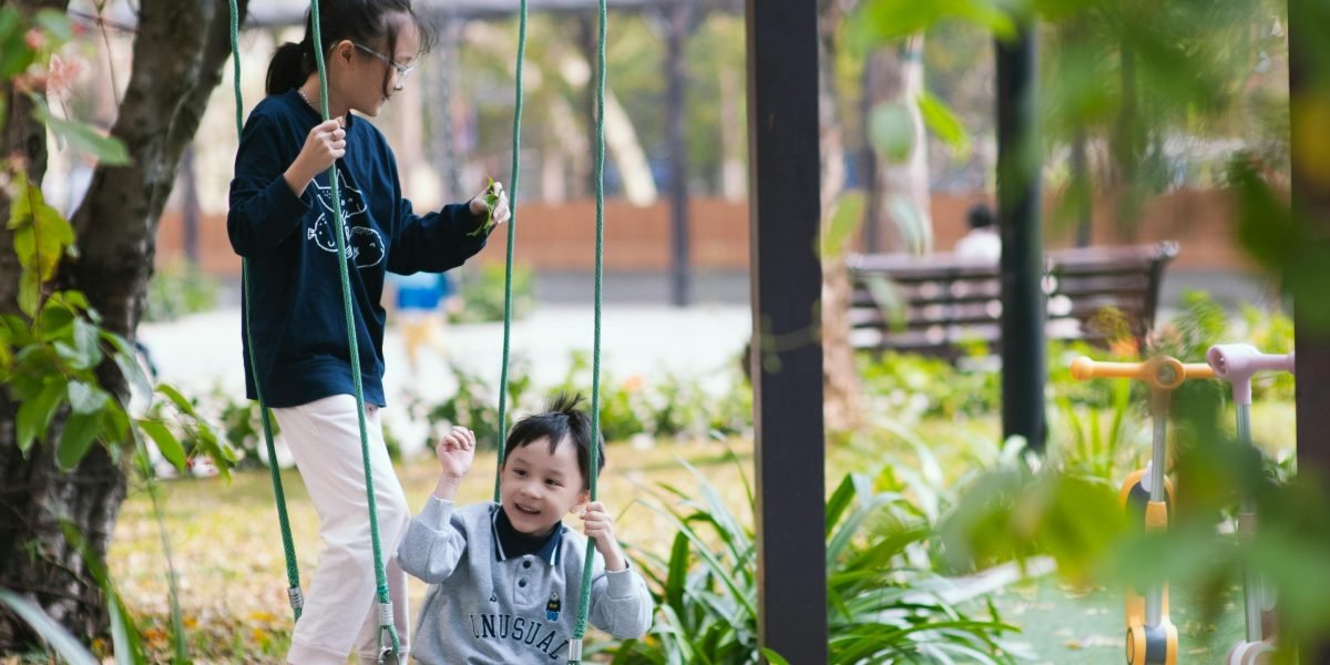A family enjoying a sunny day in a well-maintained community park, reflecting Wasl's focus on community living.