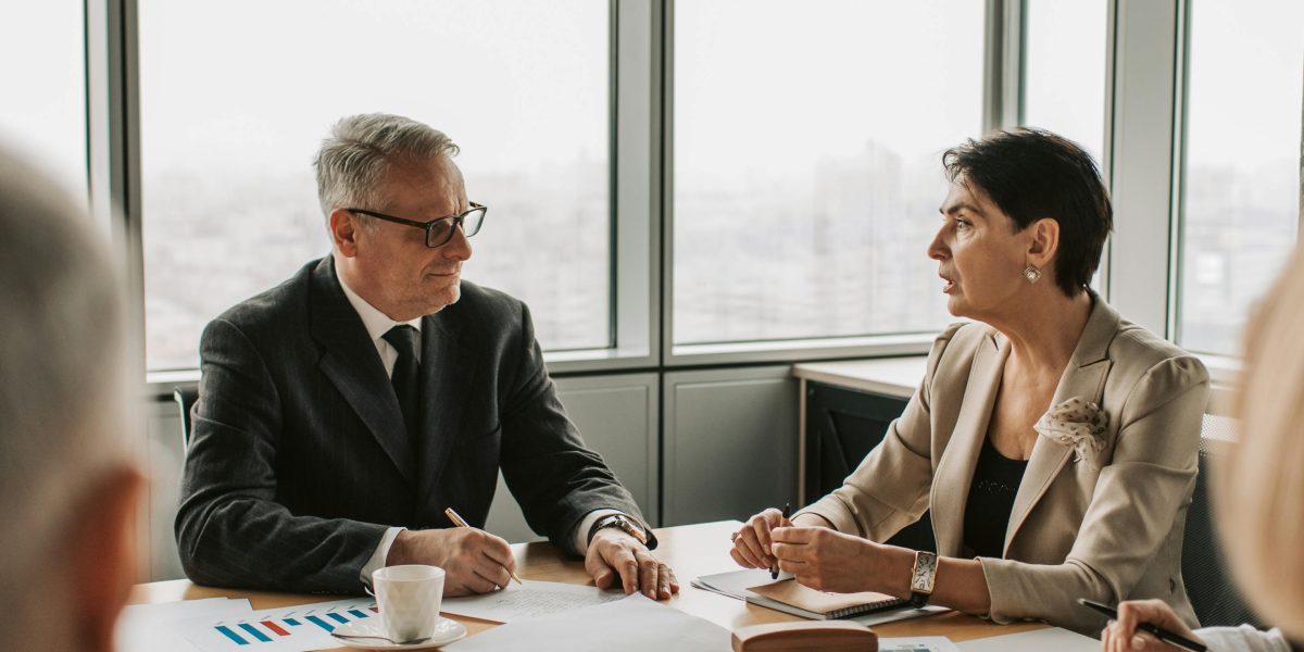 Business professionals engaged in a strategic discussion, reflecting the careful consideration needed when comparing developers.