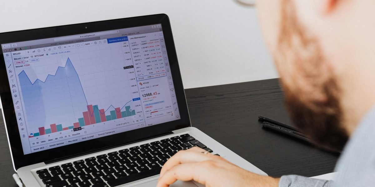 An investor meticulously examining financial data and reports to make informed decisions.