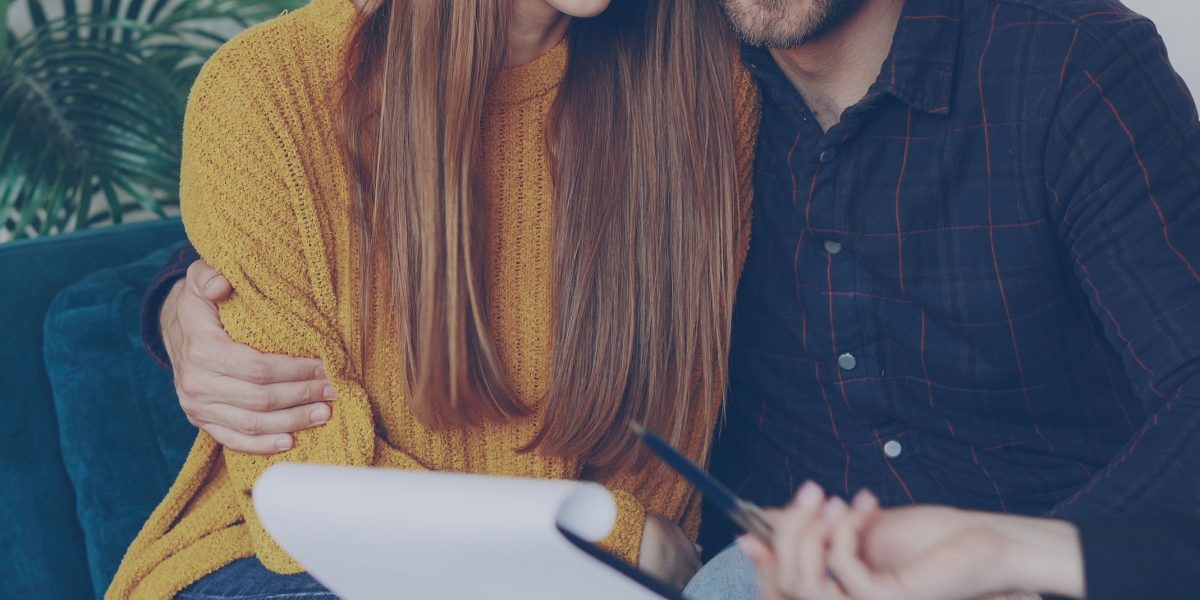 An individual discusses financial projections and budget planning with an advisor, crucial for real estate business sustainability.