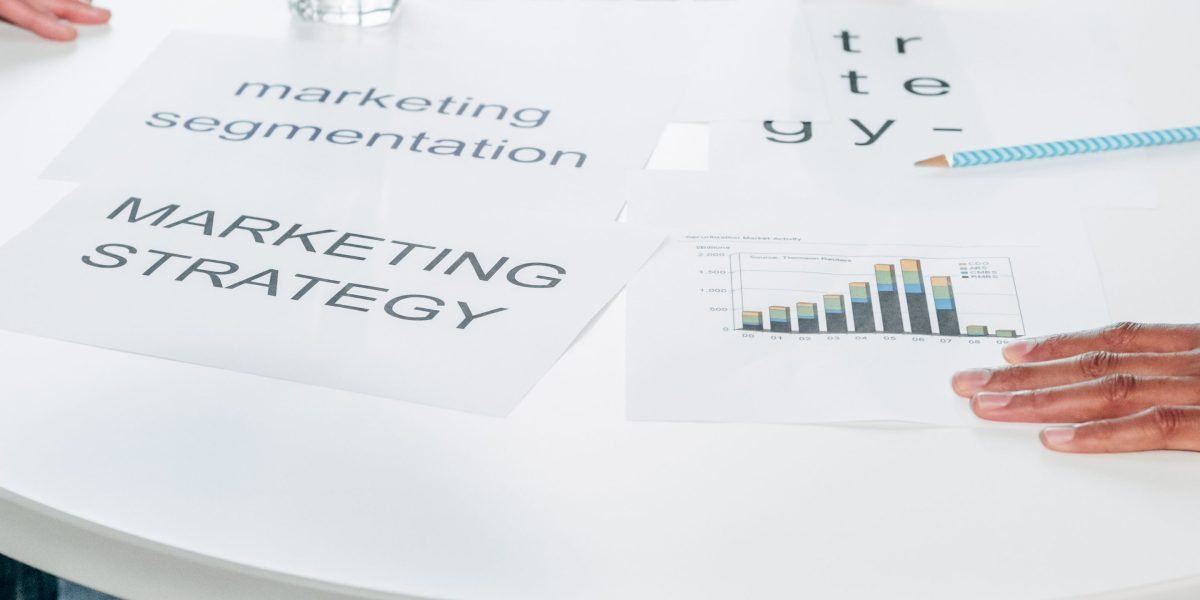A team collaborates on a marketing strategy, blending digital and traditional methods for client acquisition in real estate.
