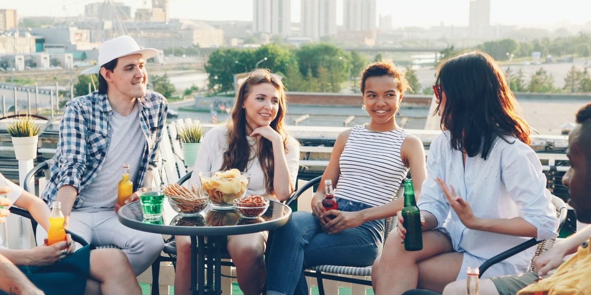 A diverse group of people observing a modern city skyline, symbolizing international interest and high demand in the real estate market.