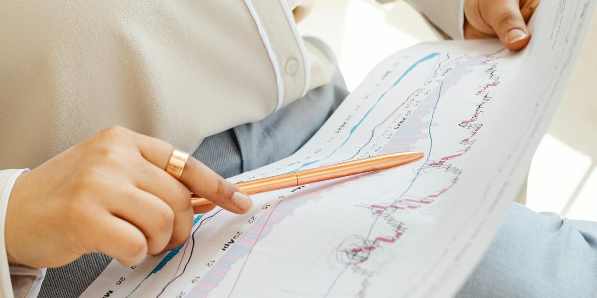 An individual focused on reviewing financial data and charts to make informed property investment decisions.
