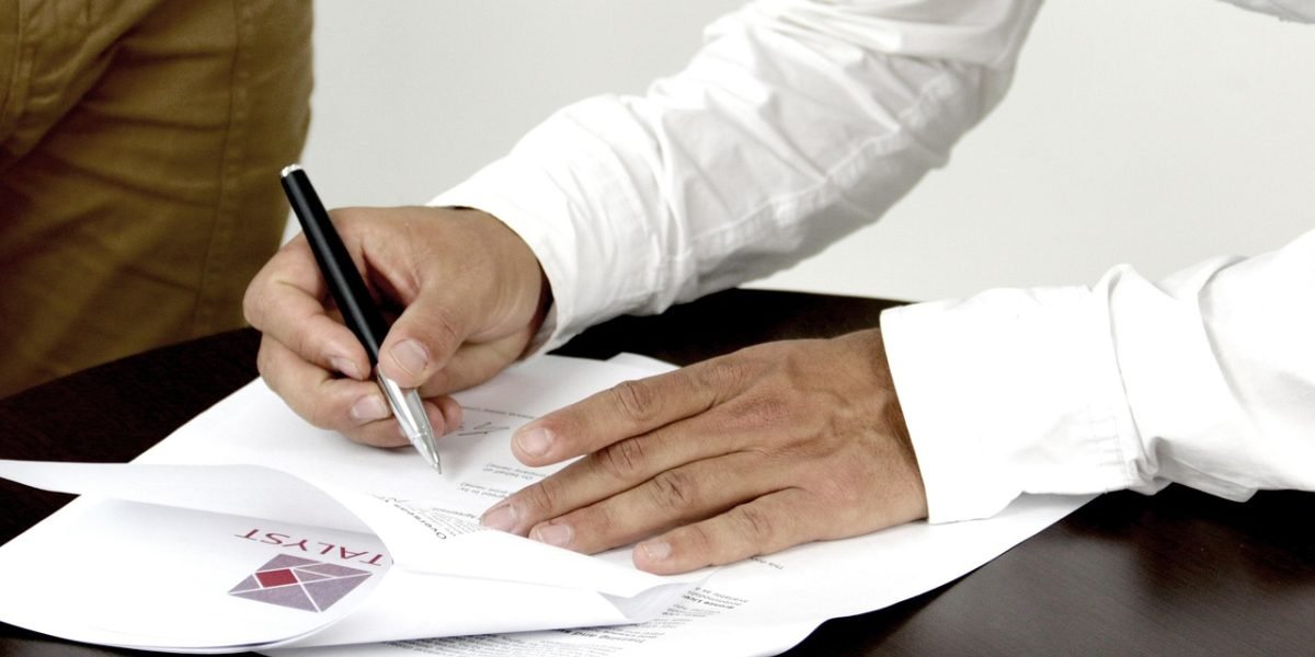 A person carefully reviewing legal documents, illustrating the importance of understanding regulations.
