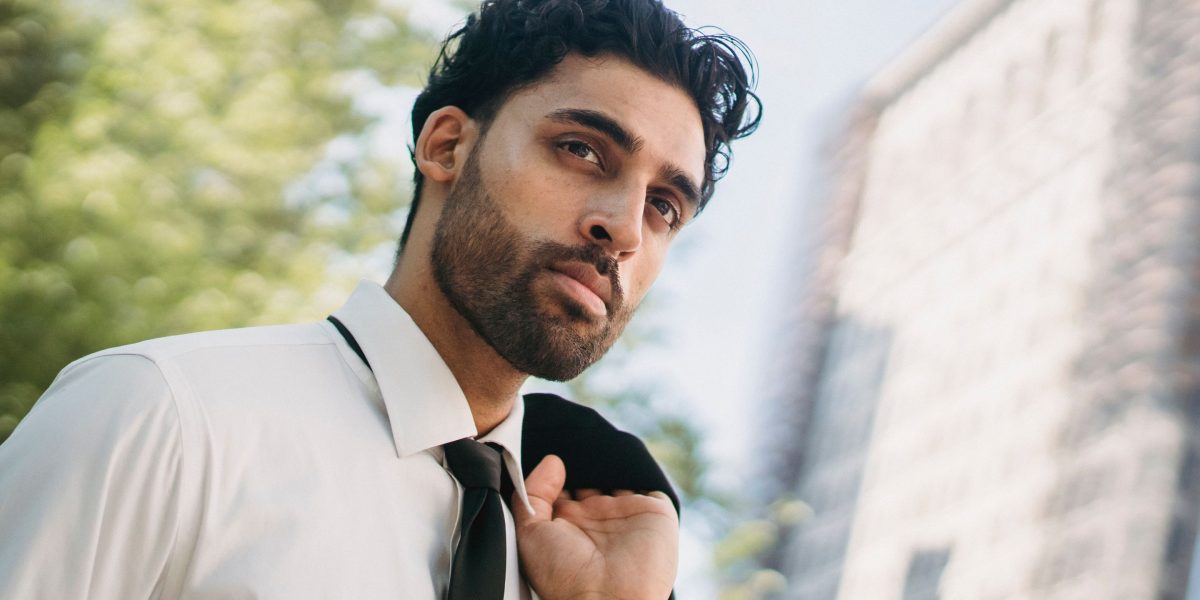 A person looking out at a modern city skyline, reflecting on investment opportunities.