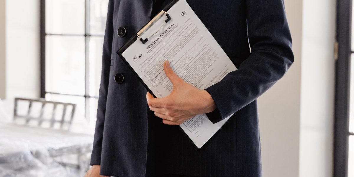 A confident individual reviewing documents, representing successful property investment.