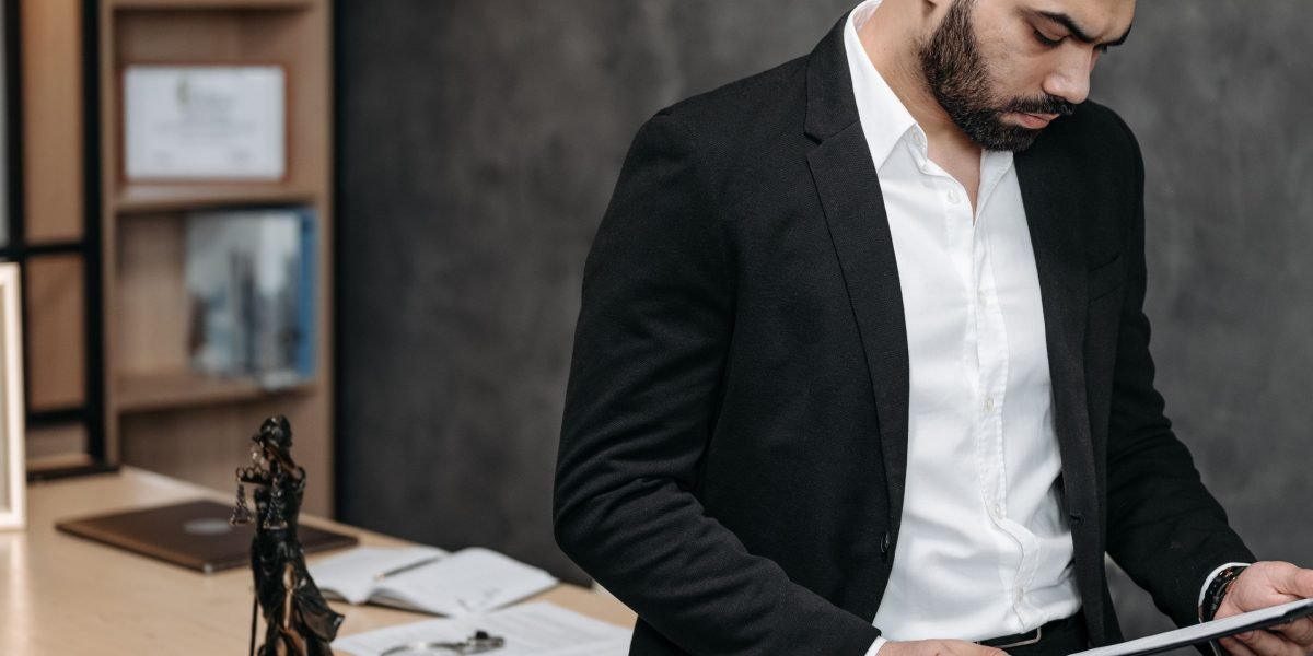 A person carefully reviewing legal or financial documents, symbolizing due diligence and avoiding common investment pitfalls.