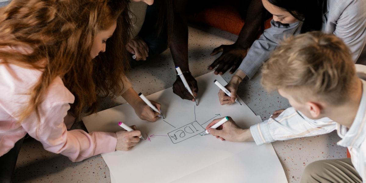 A creative team collaborating to craft a unique value proposition for a new property development.