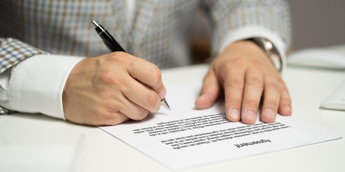 A professional meticulously reviewing legal and regulatory documents to ensure compliance in the Dubai real estate market.