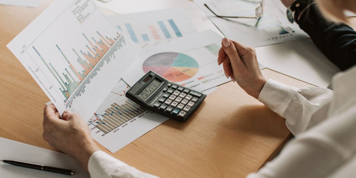 An individual thoughtfully considering financial documents, reflecting the critical decision-making process for real estate investment.