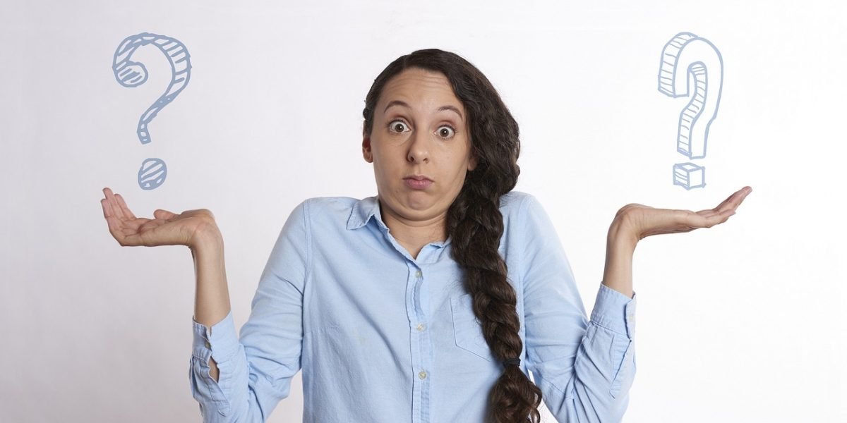 A person thoughtfully considering different real estate investment opportunities in Dubai.