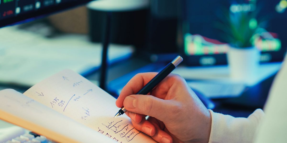 A person thoughtfully reviews financial documents, symbolizing the process of planning an investment strategy in a dynamic market.