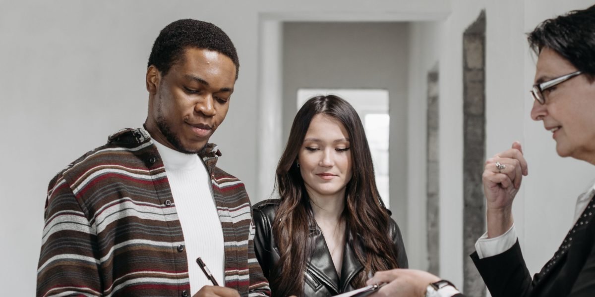A client meets with a real estate advisor, discussing options and reviewing property details to align with investment goals.