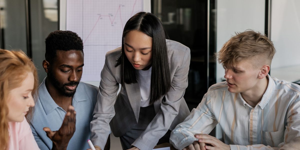 A diverse team of professionals collaborating effectively in an office, symbolizing teamwork in real estate.
