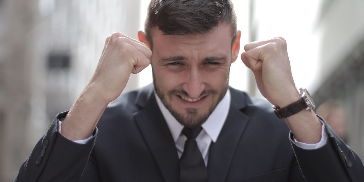 A person celebrating a significant achievement, symbolizing the rewarding outcomes of a successful real estate career.