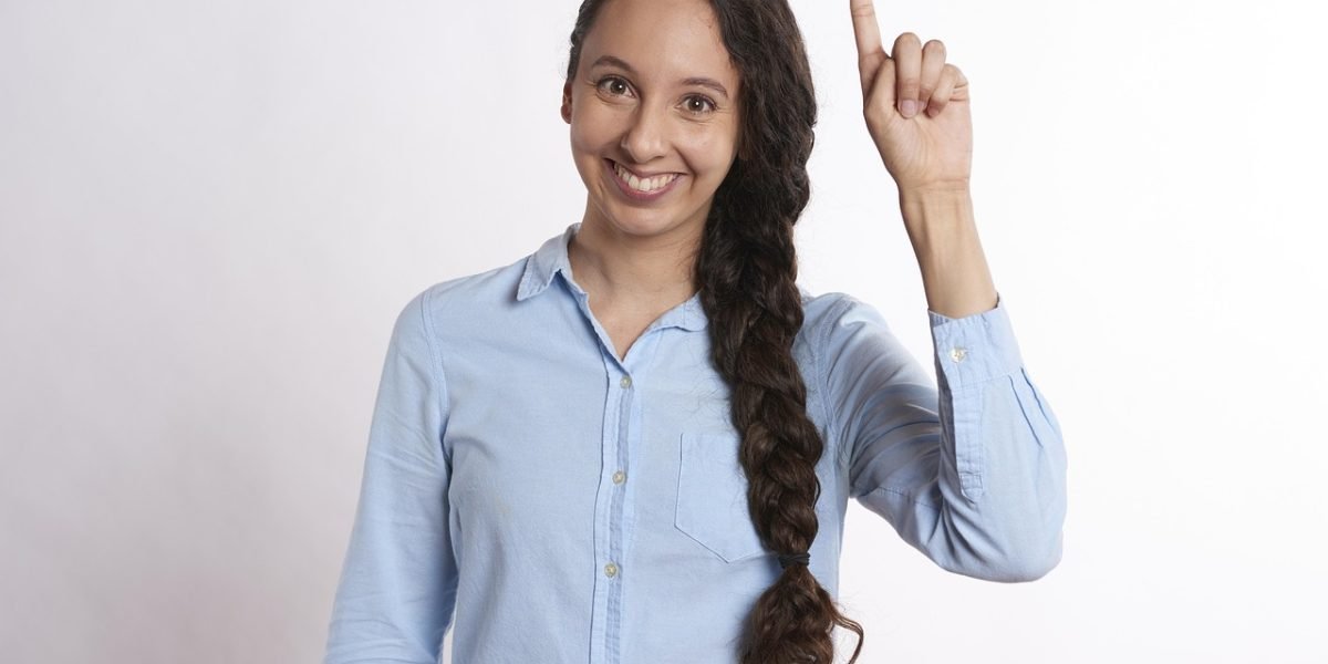 A confident person smiling in a professional business setting, representing success and satisfaction.
