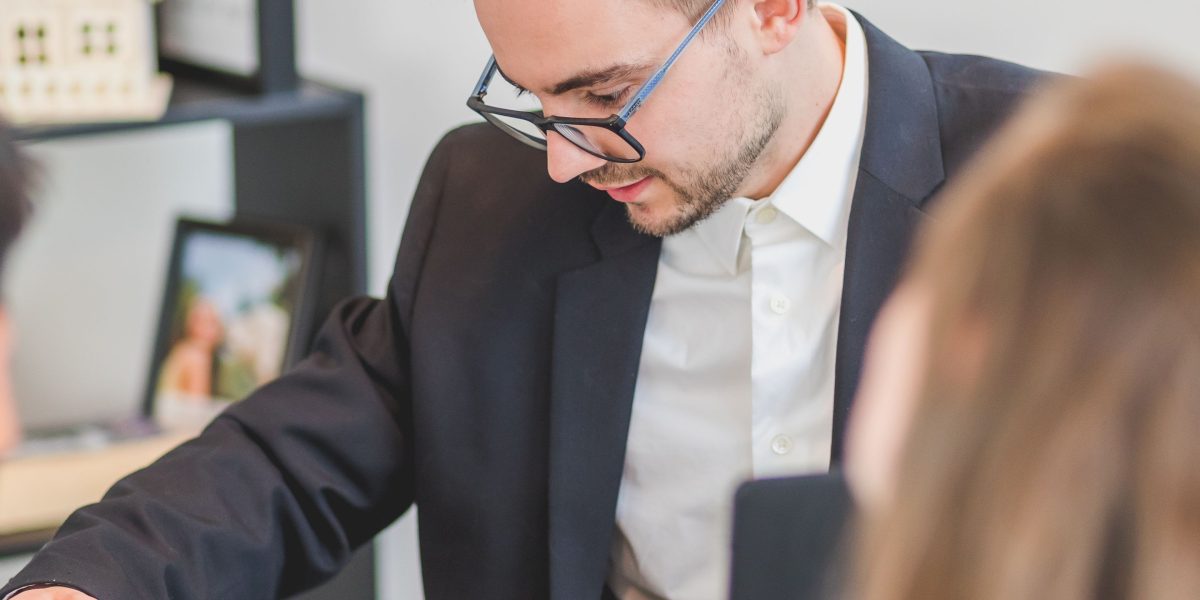 A financial advisor explains a personalized investment strategy to a client in a professional setting.
