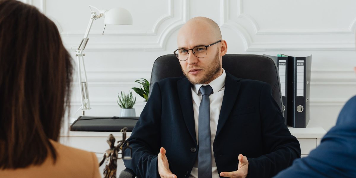 Individuals consulting with a legal advisor to navigate the complexities of property due diligence and legal verification.
