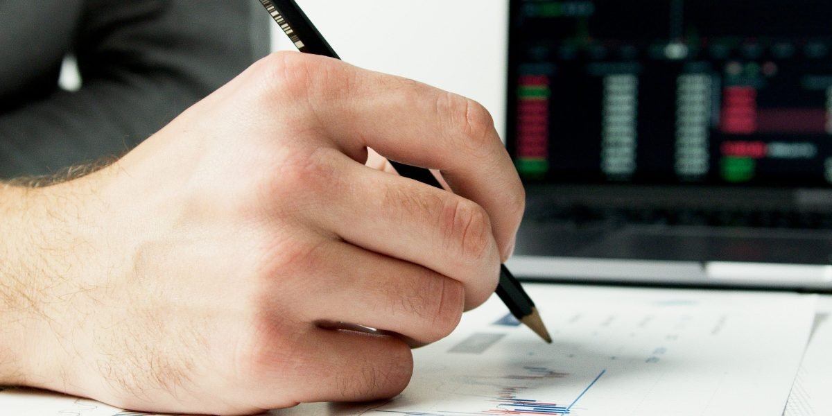 A person carefully analyzing financial data to determine potential rental yields.