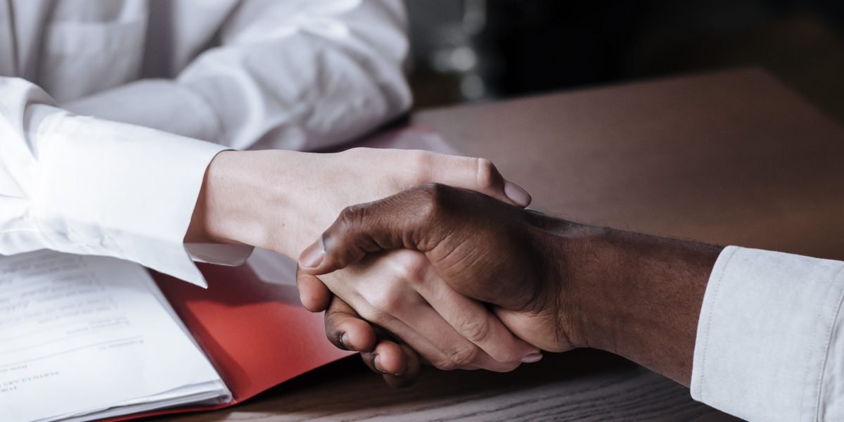 A handshake symbolizing a successful property transaction or a partnership with trusted advisors.