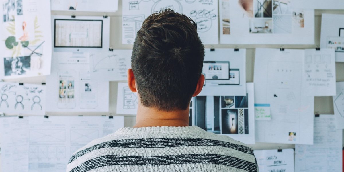 A diverse team collaborates around a whiteboard, developing strategies for a balanced investment portfolio.