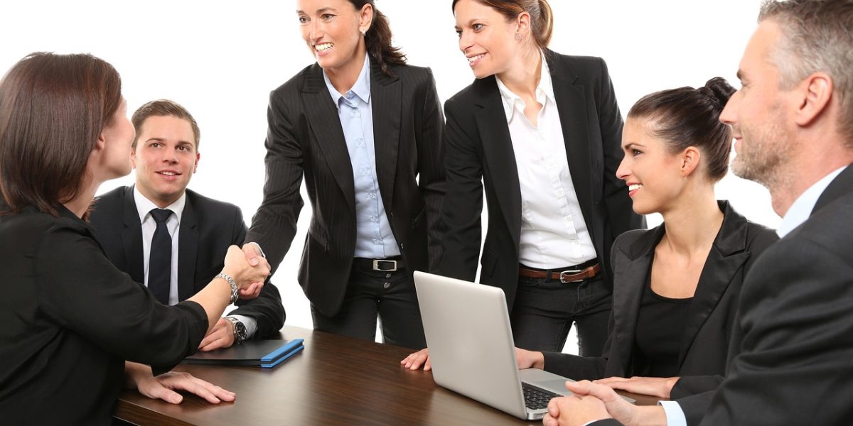 A real estate agent engaging with potential clients to understand their investment goals.